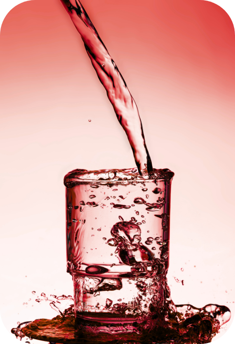 "A glass of water with red tones being filled and splashing over – representing hydration, refreshment, and Lex's brand colours"